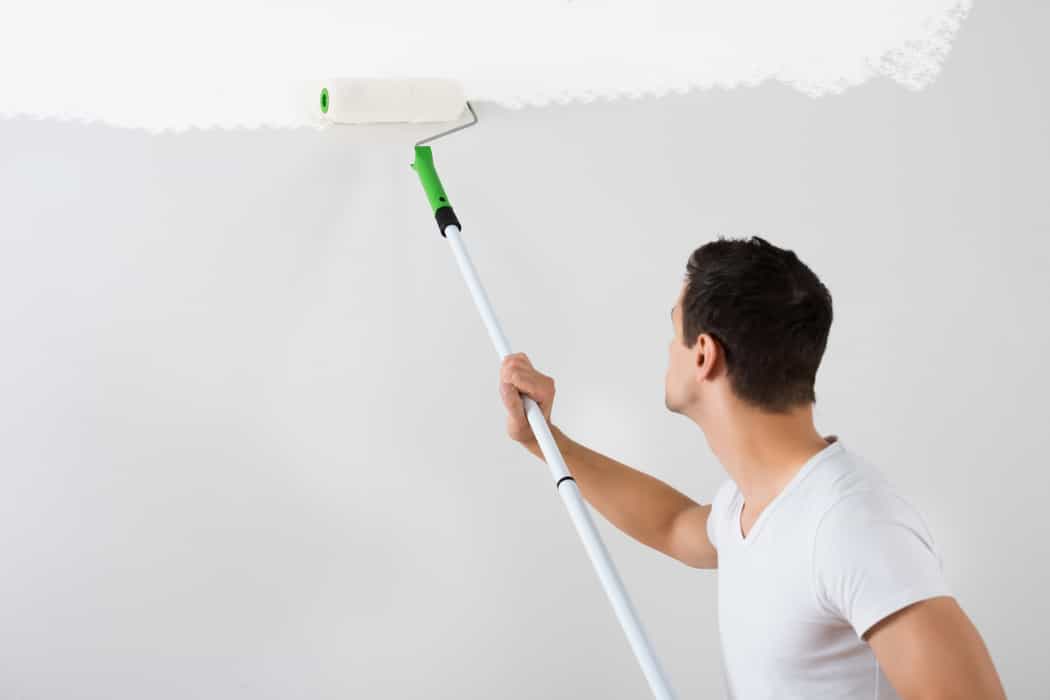 man painting with roller